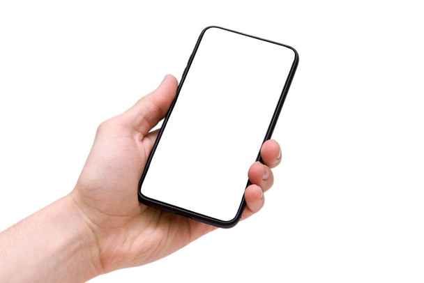 Man holding smartphone with blank screen on white background, closeup of hand. Space for text - 写真・画像