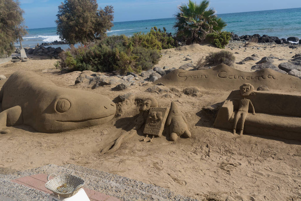 Песчаные скульптуры на пляже Мелонерас, Испания с надписью Гран-Канария - Фото, изображение