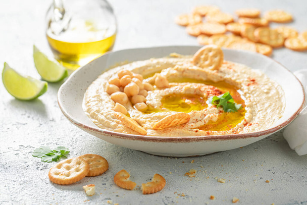 Delicious hummus as a healthy and tasty snack - Fotoğraf, Görsel