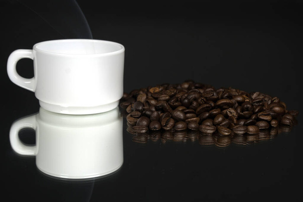 чашка кави з зернами на фоні чорного дзеркала
 - Фото, зображення