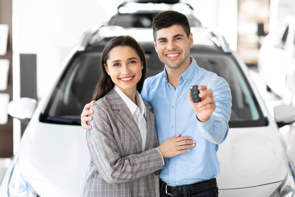 Family Showing Car Key Embracing In Dealership - Фото, изображение