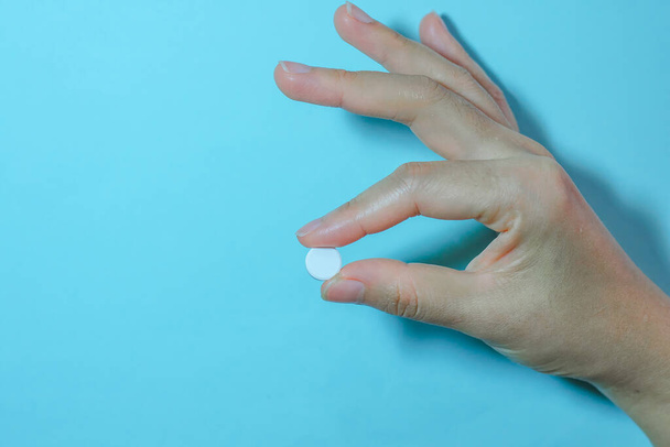 Medication on hand,White seed medicine on the finger,  - Foto, afbeelding