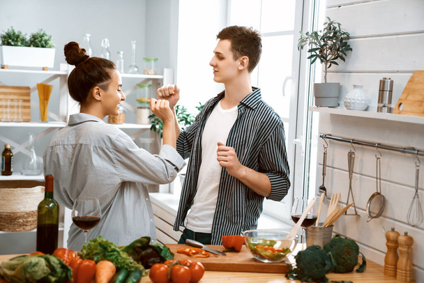 Healthy food at home. Happy loving couple is preparing the proper meal in the kitchen.  - Photo, image