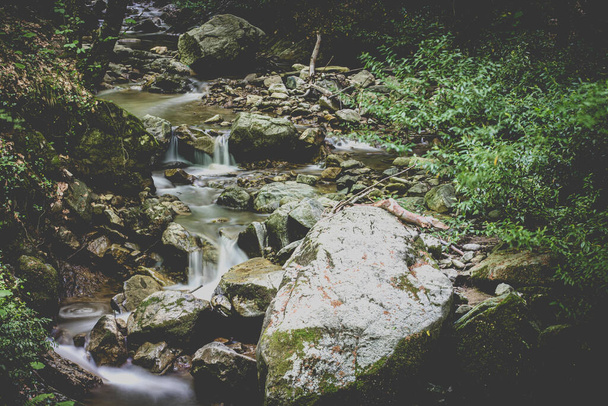 Waterfall and rocks long exposure photo in forest - Foto, Imagem