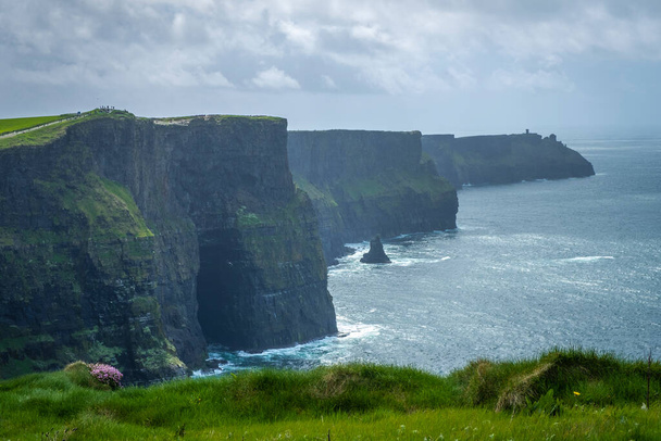 walking at the very spectacular Cliffs of Moher, Co Clare, Ireland - Photo, Image