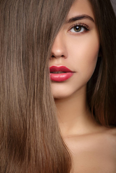 woman fashion portrait. Long straight hair covers part of her face. - Photo, Image