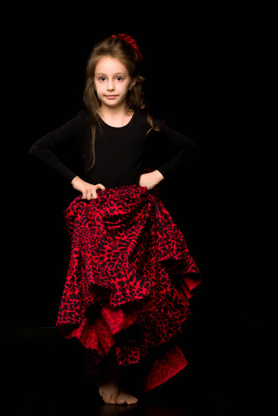 Girl Dancer in Black and Red Dress Performing on Black Backgroun - Zdjęcie, obraz