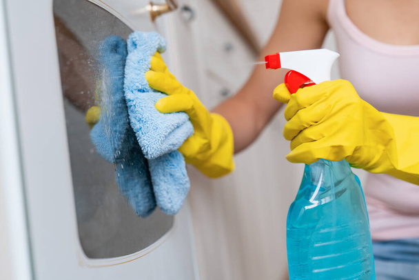 Close up of young woman cleaning modern kitchen - Photo, image