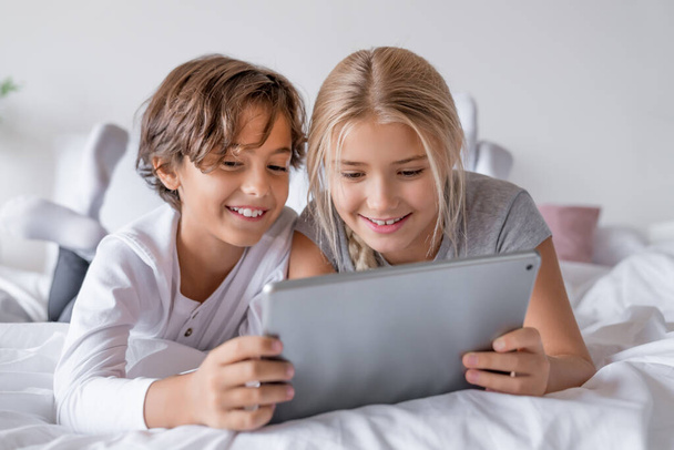 Cute little children with digital tablet using internet at home - Foto, Imagem