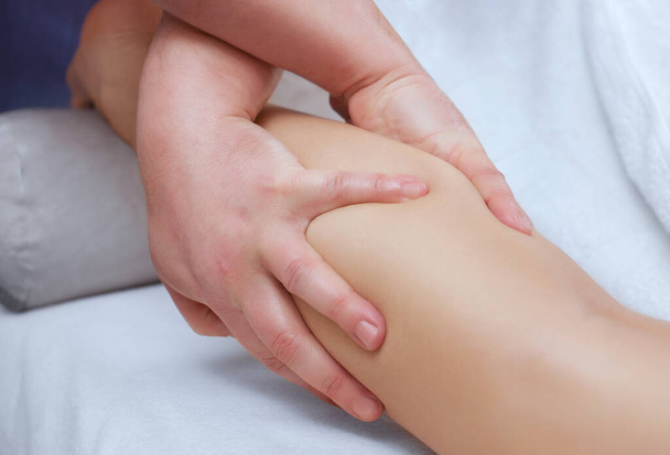 O médico-podólogo faz um exame e massagem das pernas do paciente - Foto, Imagem