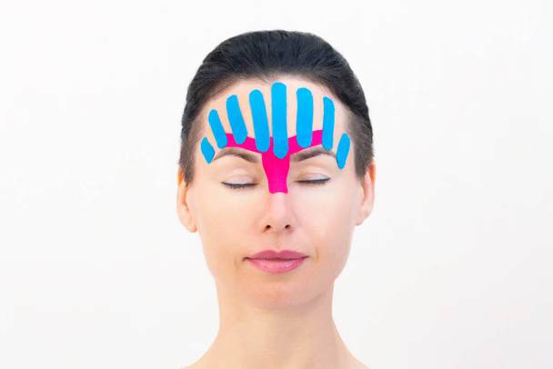 Face taping, close-up of a girls face with cosmetological anti-wrinkle tape. Face aesthetic taping. Non-invasive anti-aging lifting method for reduction of wrinkles - Photo, image