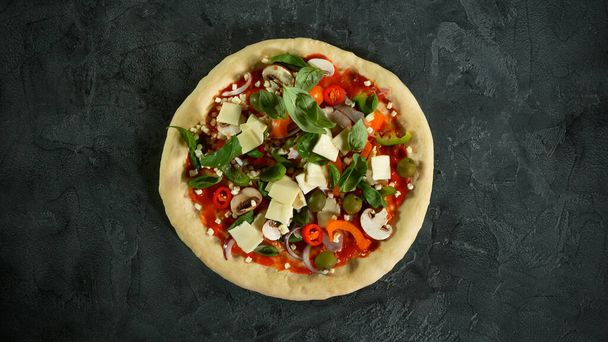 Top view of pizza meal preparation, raw ingredients inside. Italian traditional meal. - Photo, image