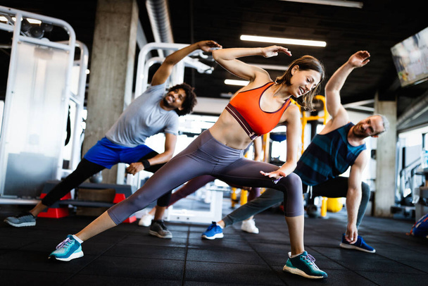 Beautiful fit friends working out in gym together - 写真・画像