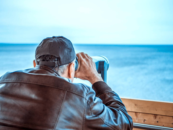 muž dívá přes turistický dalekohled.  - Fotografie, Obrázek