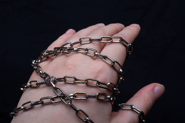 A female's hand wrapped in a chain - Photo, Image