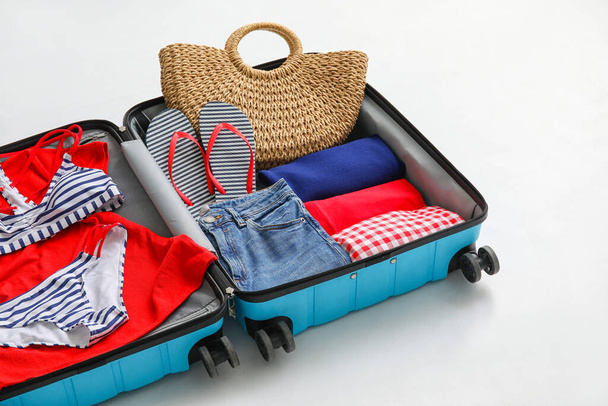 Open packed suitcase on white background - Photo, Image
