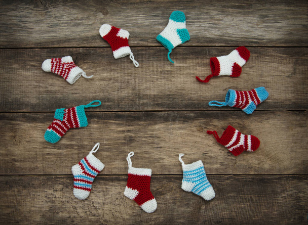 Christmas socks on old wooden background. - Foto, afbeelding