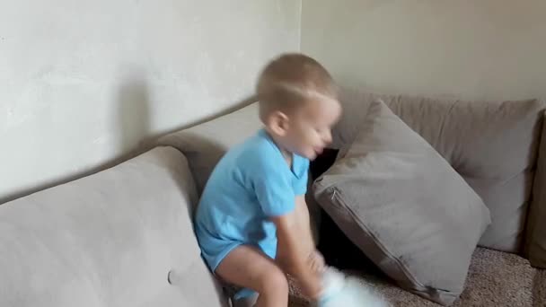 Adorable Two Year Old Boy Trying To Pull On Diaper Without Help - Filmmaterial, Video