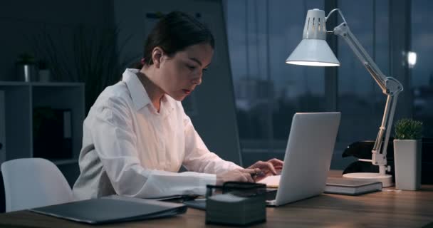 Businesswoman working at night office - Video