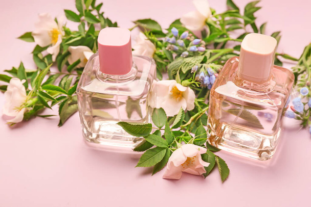 Bottles of floral perfume on color background - Photo, Image