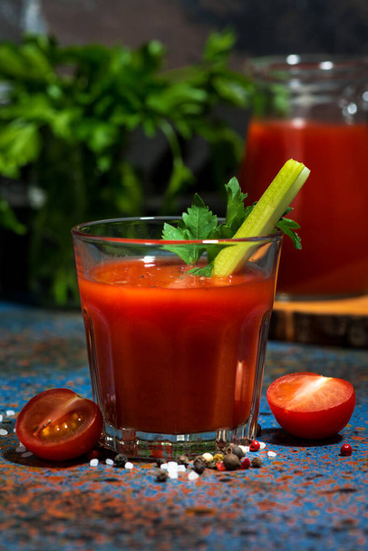 healthy tomato juice with salt and celery on dark table, closeup - Foto, Imagem