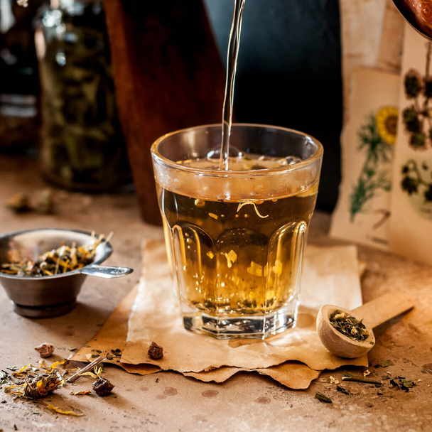 Pouring Herbal Tea into a Glass, Variety of Dried Herb Mixes, square - Photo, image