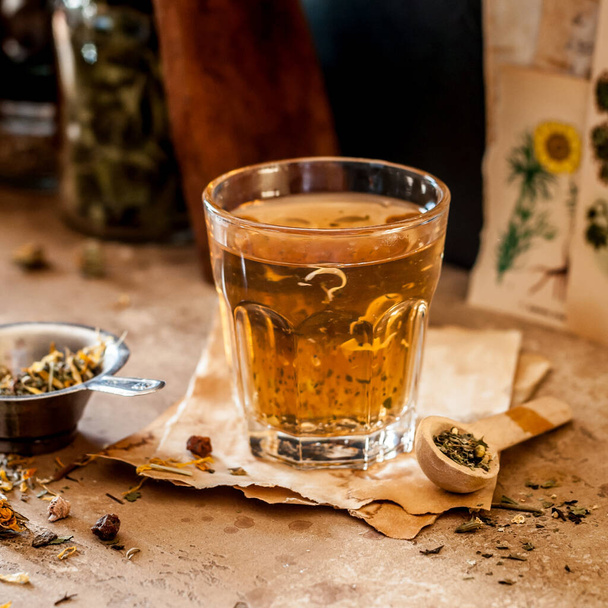 Herbal Tea in a Glass and Variety of Dried Herb Mixes, square - Foto, immagini