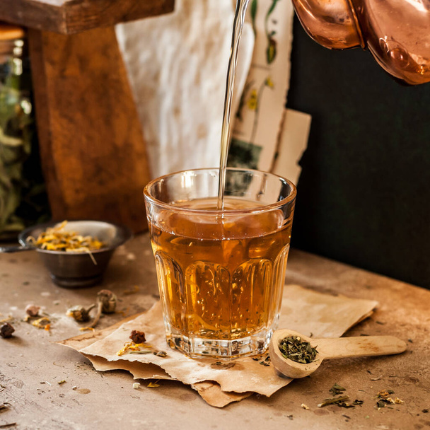 Pouring Herbal Tea into a Glass, Variety of Dried Herb Mixes, square - Valokuva, kuva
