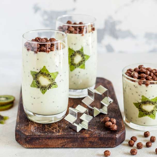 Kiwifruit Smoothie Decorated with Star Shaped Kiwi Slices with Cocoa Cereal, square - Fotó, kép
