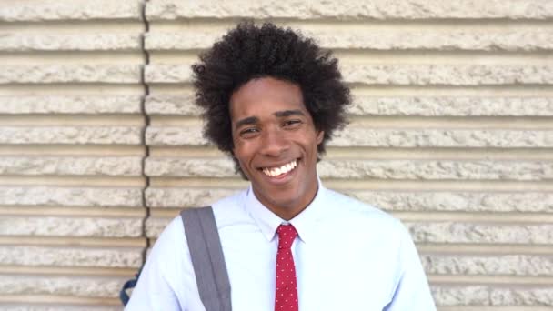 Happy Black man smiling outdoors. Guy with afro hair. - Filmmaterial, Video