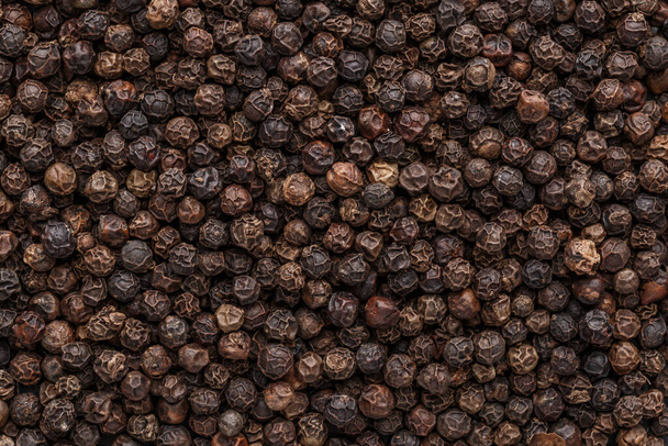 Peppercorn background. Dry black pepper seeds. Top view. Flat design. Macro spice background - Photo, image