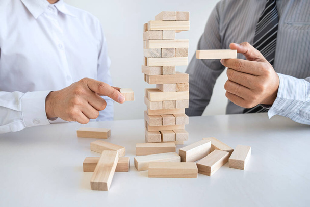 Alternative Risk and Strategy in Business, Hand of business team cooperative gambling making wooden block hierarchy on the tower to collaborative planning and development to successful
. - Фото, изображение