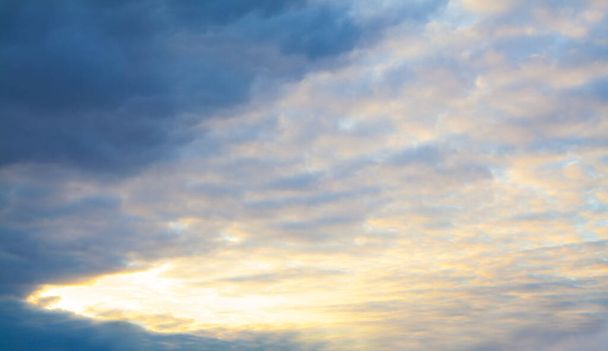 Nightly sky clouds background. Beautiful landscape with clouds and orange sun on sk - 写真・画像