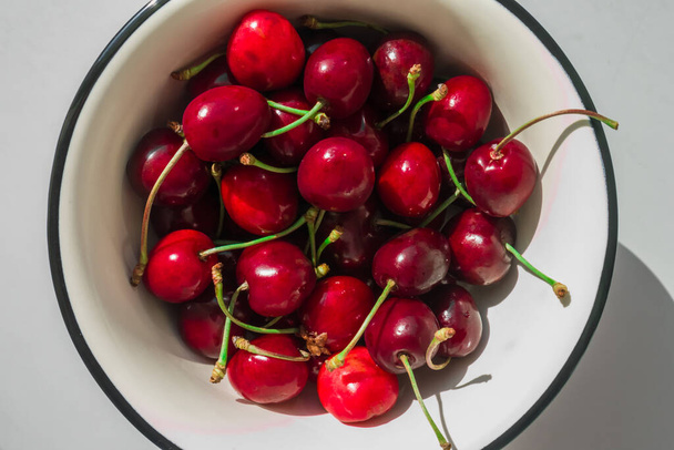 First red cherries of the year in the beginning of June, Summer. Round plate - Photo, Image