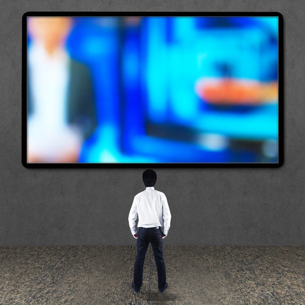 Businessman looking at TV screen - Photo, Image