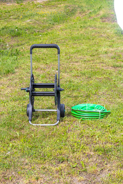 daylight. on the grass is a hose cart. close-up. - Photo, Image