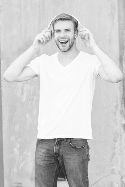 Good sound for happy experience. Happy man listen to music grey background. Handsome guy enjoy happy melody playing in headphones. Pleasure and joy. Fun and entertainment. Be happy and positive - Fotografie, Obrázek
