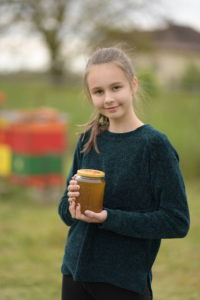 beekeeper girl works on an apiary at hive - Photo, Image