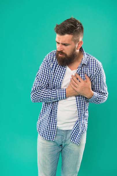 Oh my heart. Bearded man suffer from heart pain. Hipster hold hand on heart. Cardiovascular health. Heartache and chest pain. Healthcare. Preventing heart disease. Symptoms of myocardial infarction - Fotoğraf, Görsel