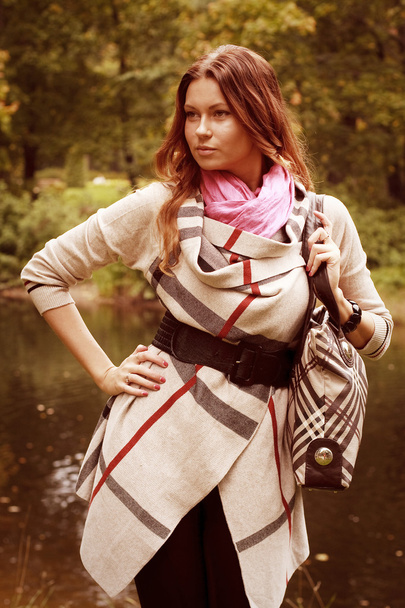 Woman near the river in autumn season - Zdjęcie, obraz