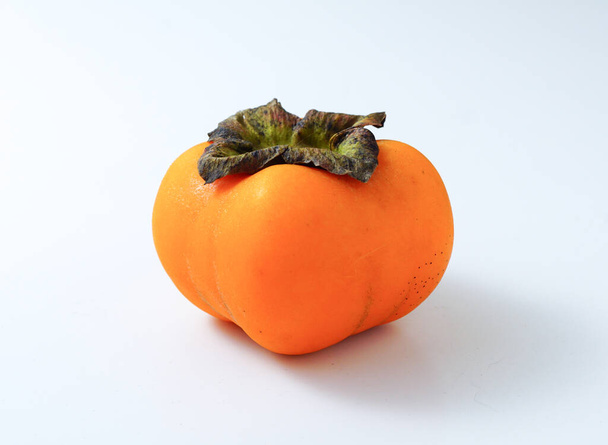 a Persimmon on the white background. - Photo, Image