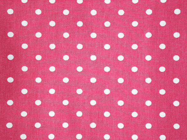 Close up surface pink cotton fabric with white polka dot pattern background. - Фото, изображение