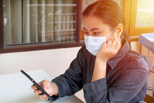 Female office worker wearing protective mask against germs - Fotó, kép