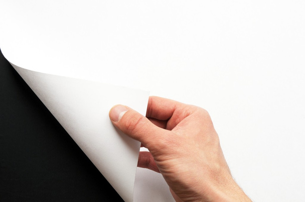 Hand turning paper - Фото, зображення