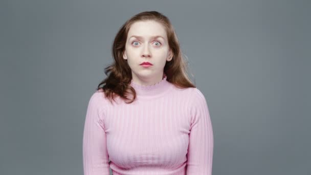 Video of scared woman in pink turtleneck - Footage, Video