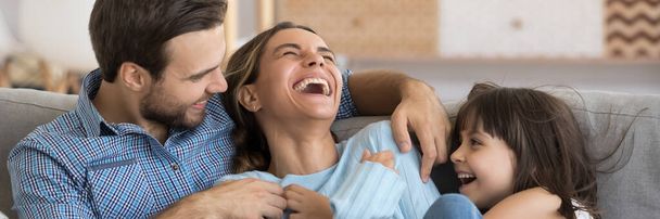 Husband and daughter tickling mother family play together enjoy weekends - Photo, Image