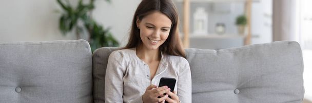 Woman holding cellphone enjoy internet fun chat with friends - Foto, Imagem