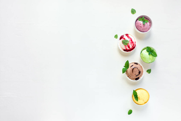 Ice Cream Set. Various italian ice creams on white background, top view, copy space. Frozen yogurt or ice cream assortment  in cups - healthy summer dessert. - Foto, immagini