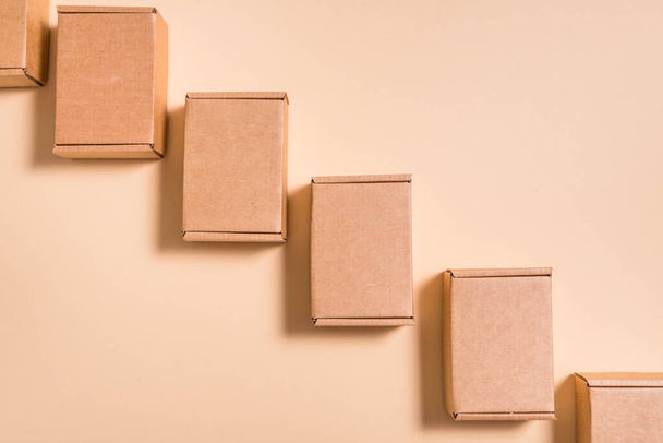 Lot of square cardboard boxes on beige background - Foto, immagini