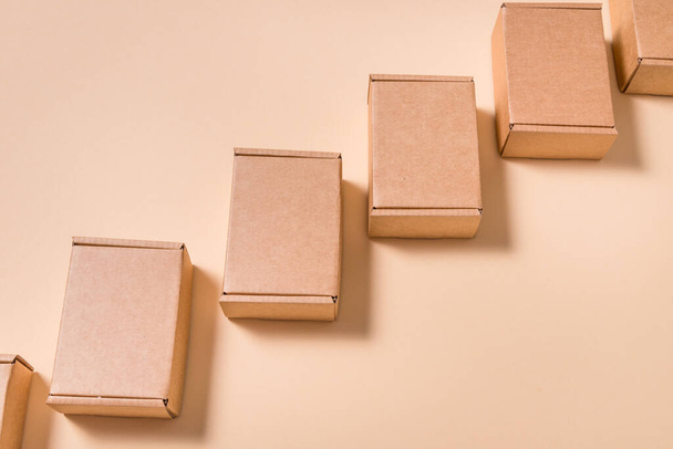 Lot of square cardboard boxes on beige background - Photo, image
